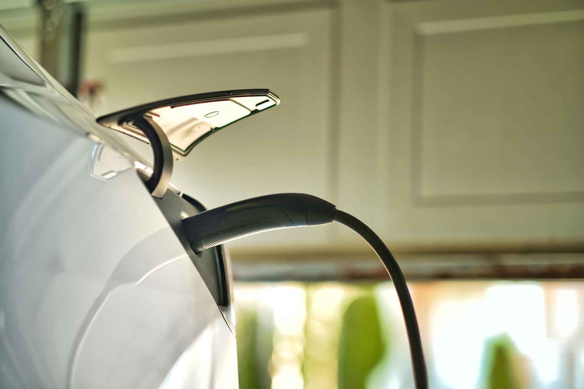 EV charging in garage with at-home EV charging station